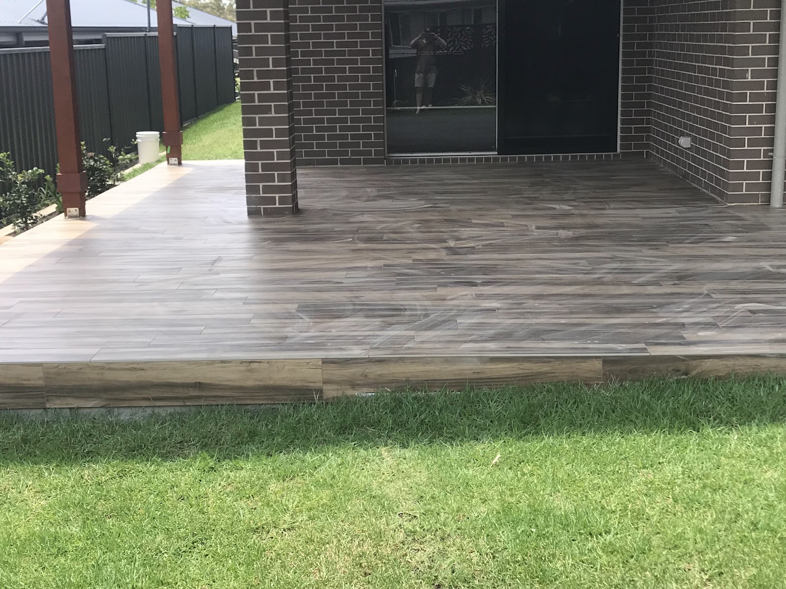 A timber-look tiled outdoor deck at a Shoalhaven home, laid by Clear Cut Tiling